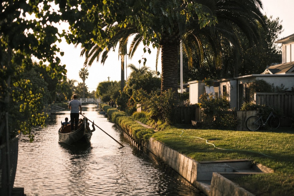 A small boat gliding through a residential canal at golden hour, no text, no logos, no people