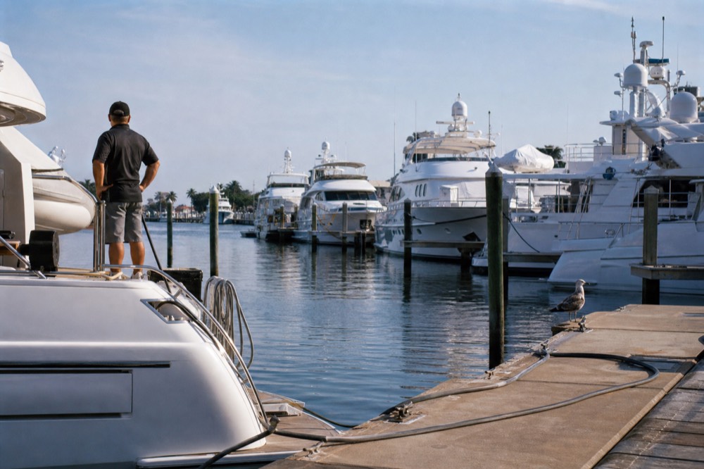 Row of luxury yachts docked at a Fort Lauderdale marina on the Intracoastal Waterway, no text, no logos, no people