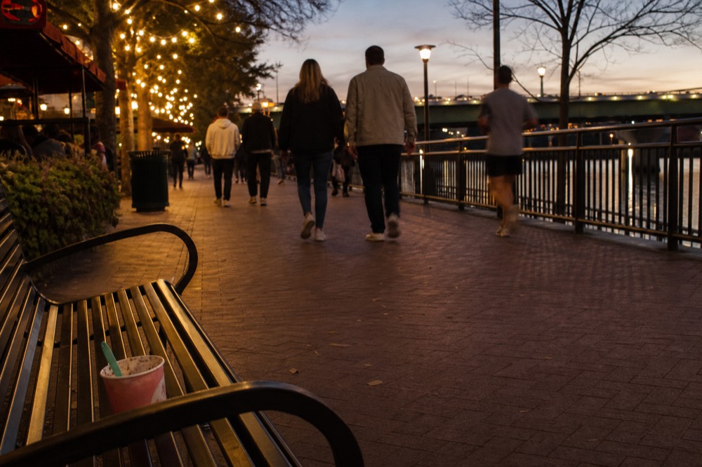 People strolling the Riverwalk promenade along the New River, no text, no logos, no people.